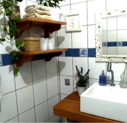 a bathroom with a sink and a mirror at Lindo quarto casal no centro Floripa in Florianópolis