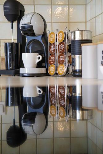 a shelf in a kitchen with a coffee maker at Savvas Apartment in Tolo