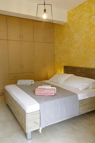 a bedroom with a bed with two towels on it at Savvas Apartment in Tolo