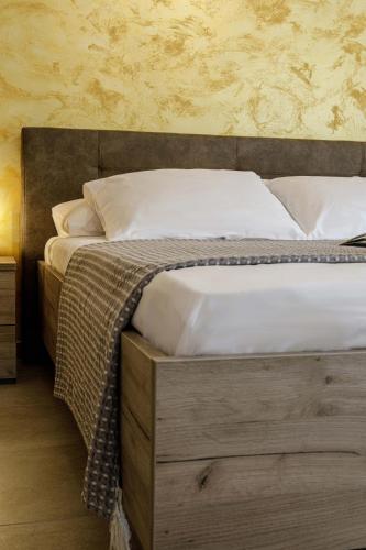 a bedroom with a large bed with a wooden headboard at Savvas Apartment in Tolo