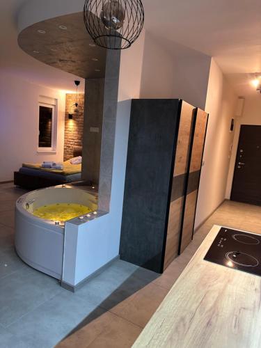 a bathroom with a tub in the middle of a room at Apartman North in Mladenovac