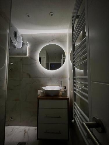 a bathroom with a sink and a mirror at Apartman North in Mladenovac