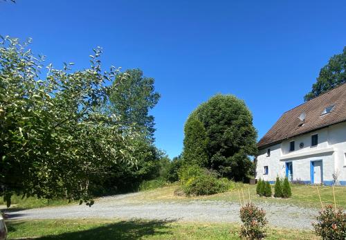 ein altes Haus und Bäume an einem sonnigen Tag in der Unterkunft Urlaub in der Natur in Lüdenscheid