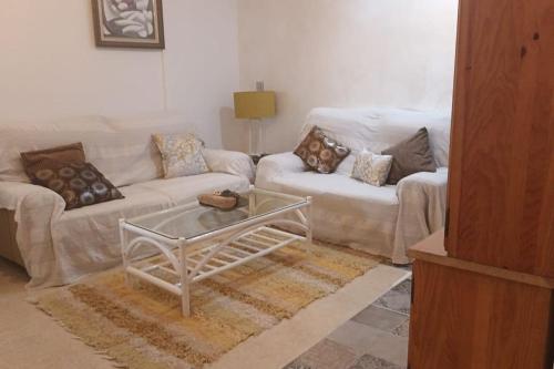 a living room with two couches and a coffee table at ApartPlaya (1ª Línea) in Melilla