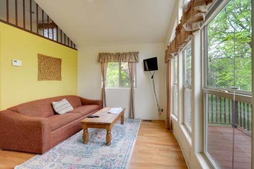 a living room with a couch and a table at Winery Cabin in Fredericksburg with Wraparound Deck! in Fredericksburg