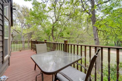 a patio with a table and chairs on a deck at Winery Cabin in Fredericksburg with Wraparound Deck! in Fredericksburg