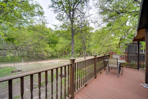 a wooden porch with a bench on a wooden deck at Winery Cabin in Fredericksburg with Wraparound Deck! in Fredericksburg