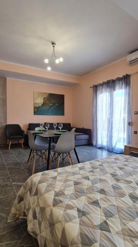 a room with a bed and a table and chairs at Eretria Apartments EK9 in Eretria