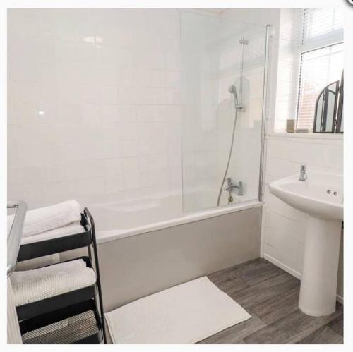 a white bathroom with a shower and a sink at CoastGuard Cottage 3 Bed House Pet Friendly, Close to Spurn Contractors Welcome in Hull