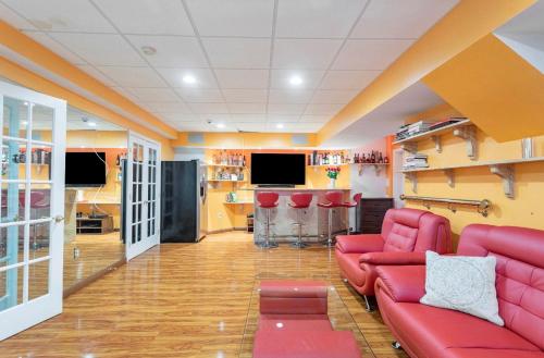 a living room with a red couch and a bar at Villa Verde B&B, bsm, Greenwood Lake, NY in Monroe