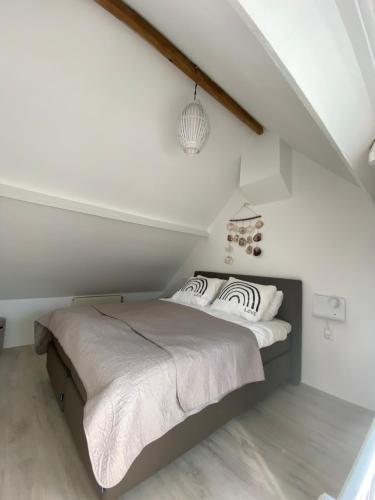 a bedroom with a bed in a attic at SeaStay in Noordwijk