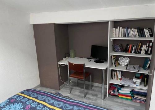 une chambre avec un bureau avec un ordinateur et une étagère dans l'établissement Joli duplex en centre ville de 40m2 climatisé, à Istres