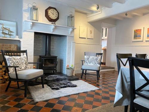 a living room with two chairs and a fireplace at Boothorpe Farmhouse in Blackfordby