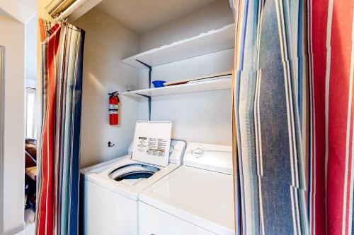 a small laundry room with a washer and dryer at Main Deck in Pacific City