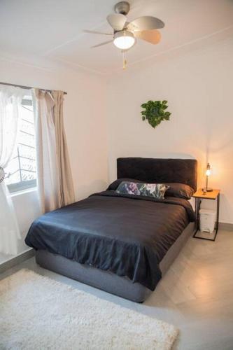 a bedroom with a bed and a ceiling fan at Roma Guesthouse in the Heart of Lusaka in Lusaka
