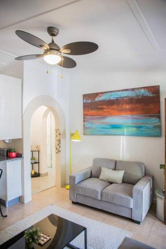 a living room with a couch and a ceiling fan at Roma Guesthouse in the Heart of Lusaka in Lusaka