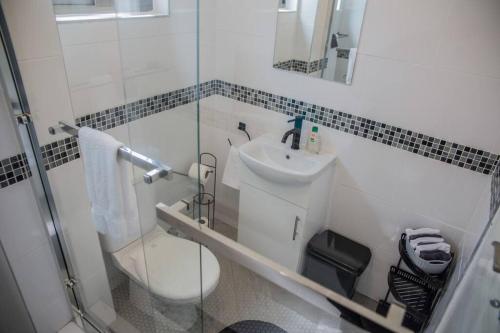 a bathroom with a toilet and a sink at Roma Guesthouse in the Heart of Lusaka in Lusaka
