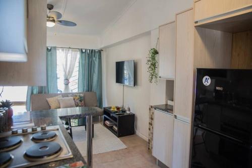 a kitchen and living room with a couch and a table at Roma Guesthouse in the Heart of Lusaka in Lusaka