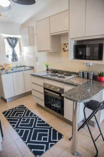 a kitchen with a counter and a stove top oven at Roma Guesthouse in the Heart of Lusaka in Lusaka