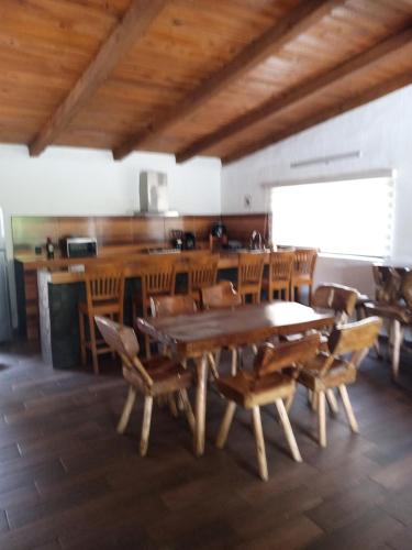 a dining room with a large wooden table and chairs at Mazamitla Pinos del Rio in Mazamitla