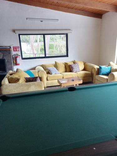 a living room with a couch and a pool table at Mazamitla Pinos del Rio in Mazamitla