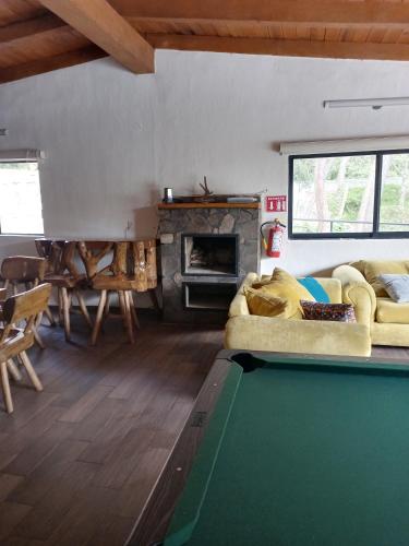 a living room with a pool table and a fireplace at Mazamitla Pinos del Rio in Mazamitla