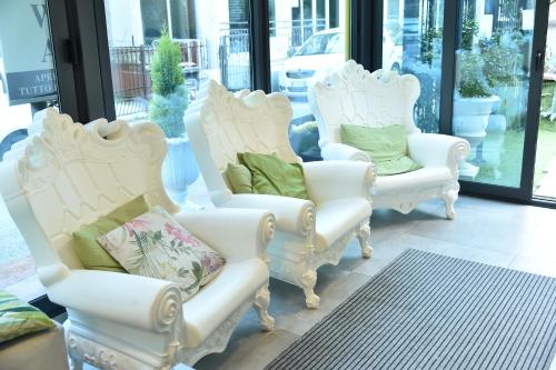 a group of white chairs sitting in a store window at Hotel Okinawa in Rimini