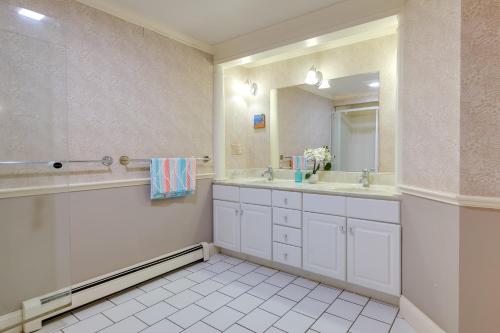 a bathroom with two sinks and a large mirror at 1 Mi to Beach Spacious Retreat in East Sandwich! in East Sandwich