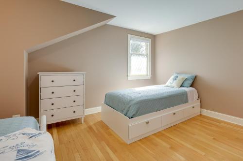 a bedroom with a bed and a dresser and a window at 1 Mi to Beach Spacious Retreat in East Sandwich! in East Sandwich