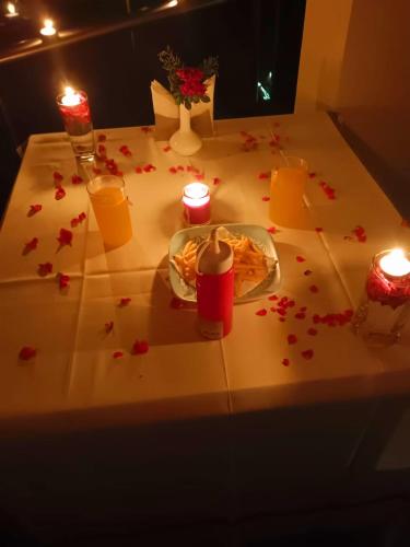 a table with a plate of food and candles and flowers at Salora Kodai in Kodaikānāl