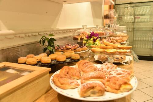 a buffet with several plates of pastries and other foods at Hotel Okinawa in Rimini