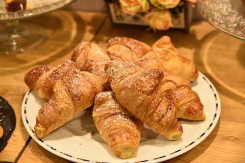 a plate of pastries on a wooden table at Hotel Okinawa in Rimini