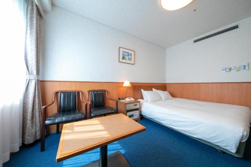Postel nebo postele na pokoji v ubytování Ise Pearl Pier Hotel