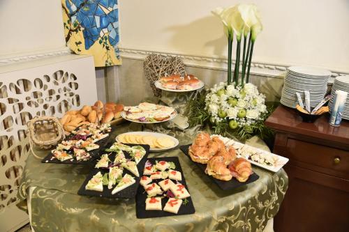 a table with different types of food on it at Hotel Okinawa in Rimini