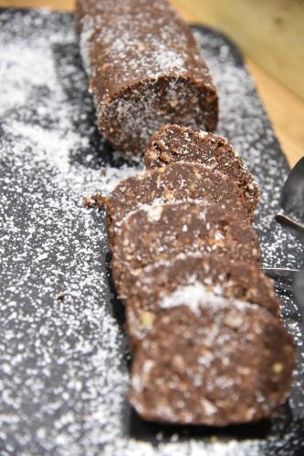 two brownies sitting on a table with powdered sugar at Hotel Okinawa in Rimini