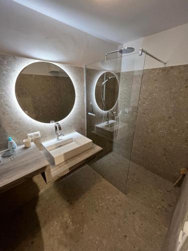 a bathroom with a sink and a mirror at Art & View - Apartment in Bad Gastein