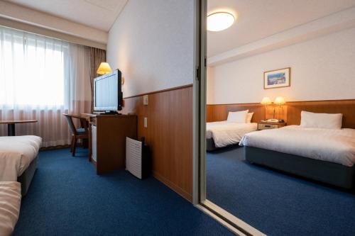 Postel nebo postele na pokoji v ubytování Ise Pearl Pier Hotel