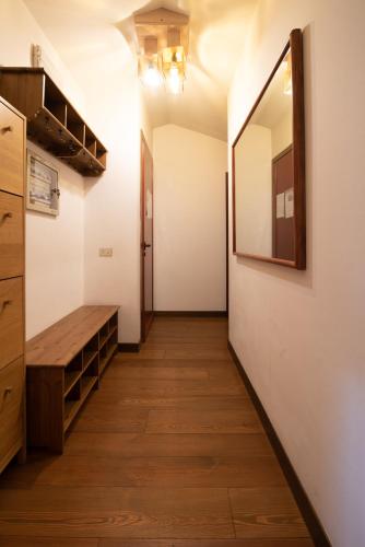 a hallway of a room with a wooden floor and a mirror at Residence La Fenice in Padova