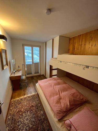 a bedroom with a bunk bed and a desk at Art & View - Apartment in Bad Gastein