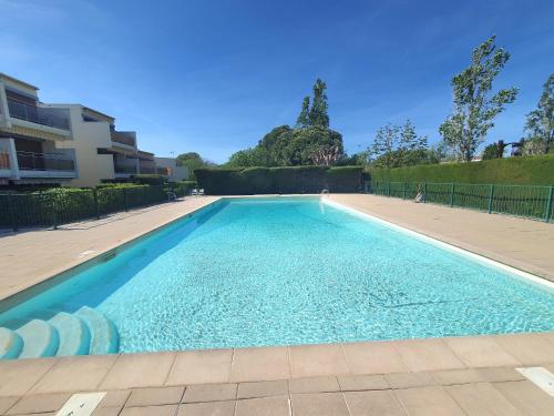 uma piscina com água azul num quintal em SEA SIDE em Mandelieu-la-Napoule