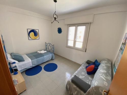 a living room with two beds and a couch at Vista Azzurra in Marina di Modica