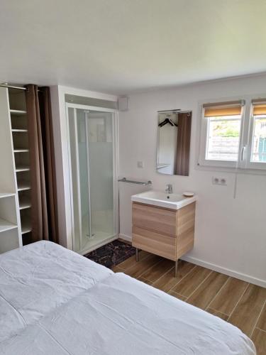 a white bedroom with a sink and a shower at Les Tourtereaux in Tarnos