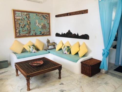 a living room with a couch and a table at La Bastide in Skiros