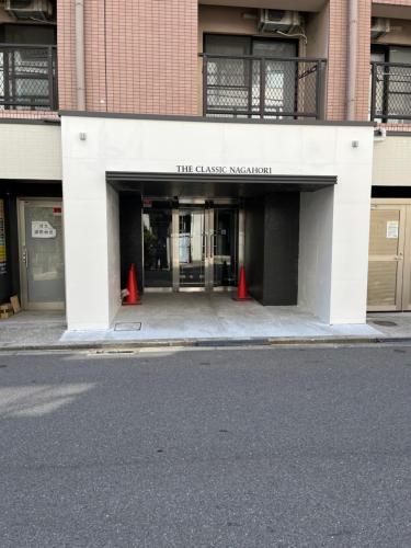 an entrance to a building with two red cones at Dotonbori Condo♡Shinsaibashi 302 (100-3) in Osaka