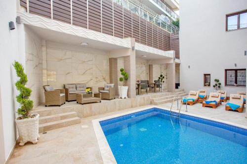 a swimming pool in the middle of a house at Kavala Resort & Spa in Néa Karváli