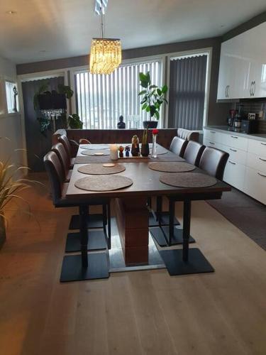 a wooden table in a kitchen with a dining room at Modern loftsleilighet in Fredrikstad