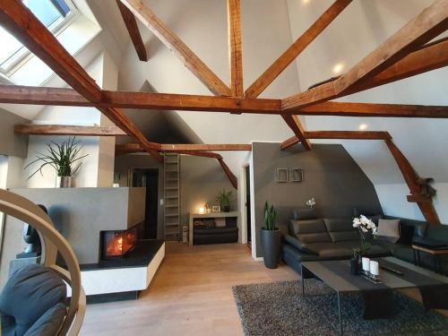 a living room with a couch and a fireplace at Modern loftsleilighet in Fredrikstad