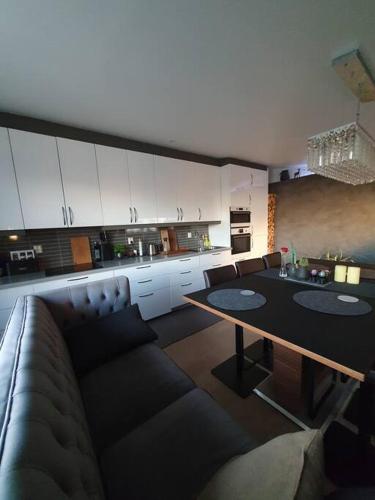 a living room with a couch and a table at Modern loftsleilighet in Fredrikstad