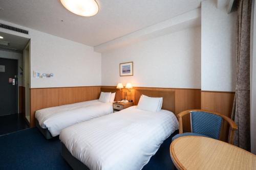 Postel nebo postele na pokoji v ubytování Ise Pearl Pier Hotel