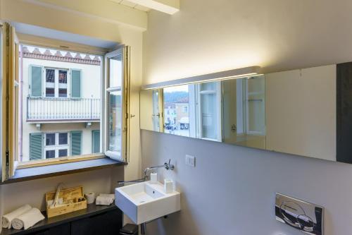 a bathroom with a sink and a mirror and a window at IL CANTUN in Monforte dʼAlba